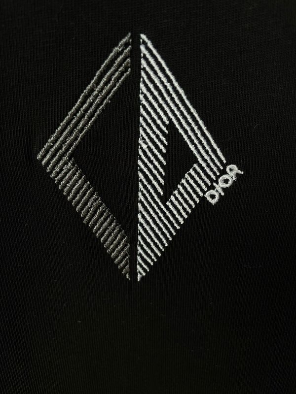 Christian Dior geometric logo close up on black luxury men's designer t shirt premium cotton Dior logo detail