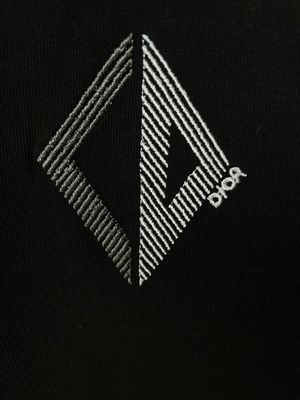 Christian Dior geometric logo close up on black luxury men's designer t shirt premium cotton Dior logo detail