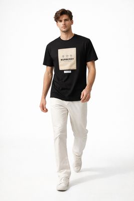 Burberry black logo patch men's t-shirt worn by male model walking pose luxury designer outfit
