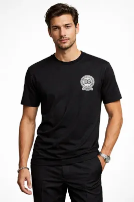 male model wearing Dolce &amp; Gabbana black DG crest logo designer t shirt luxury menswear fashion
