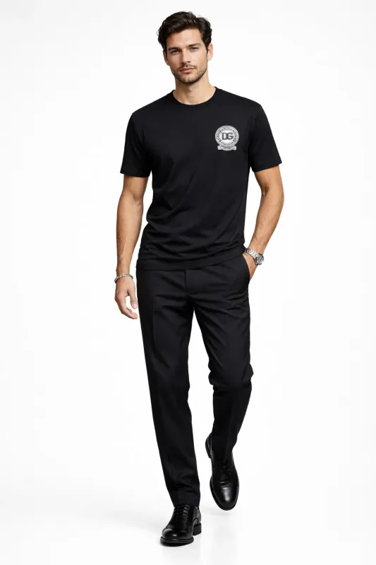 male model walking wearing Dolce &amp; Gabbana black DG crest designer t shirt luxury menswear fashion outfit
