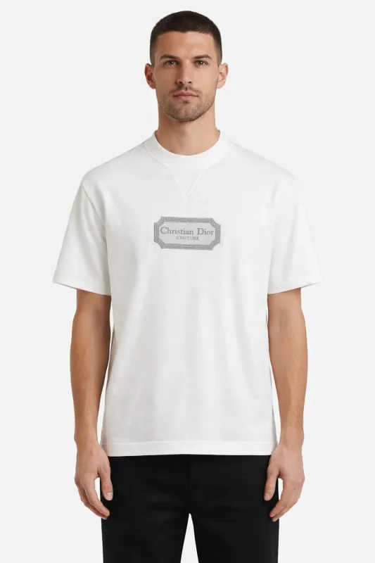 Male model wearing Christian Dior Couture white designer t-shirt with embroidered logo luxury men's fashion front view