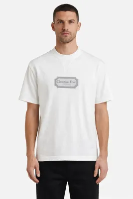 Male model wearing Christian Dior Couture white designer t-shirt with embroidered logo luxury men's fashion front view
