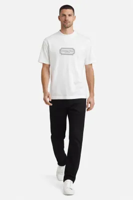 Male model walking wearing Christian Dior Couture white designer t-shirt luxury men's fashion outfit front walking pose