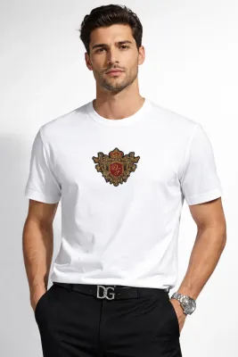 male model wearing dolce gabbana baroque crest white designer t shirt luxury italian embroidered emblem fashion for men studi