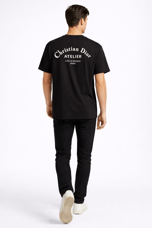 male model walking wearing black Christian Dior Atelier back logo designer t shirt luxury men's Dior Paris fashion