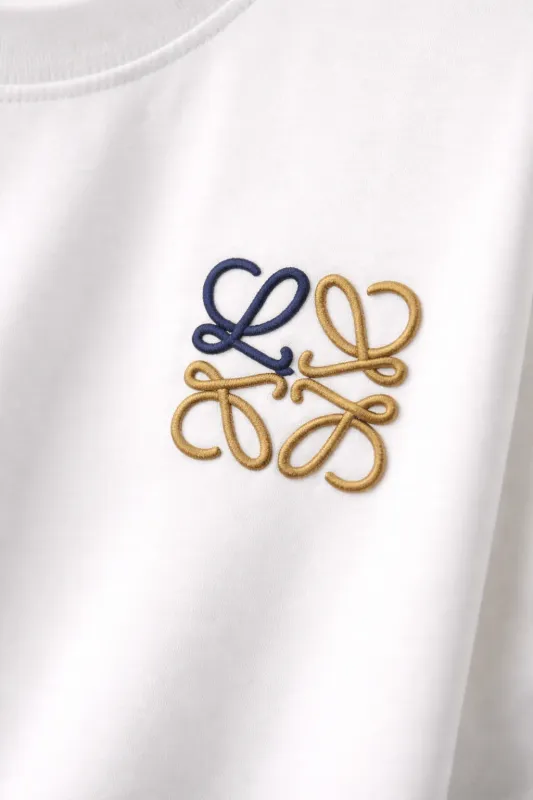 Close-up of Loewe minimal logo t shirt embroidered chest detail on white fabric