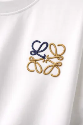 Close-up of Loewe minimal logo t shirt embroidered chest detail on white fabric
