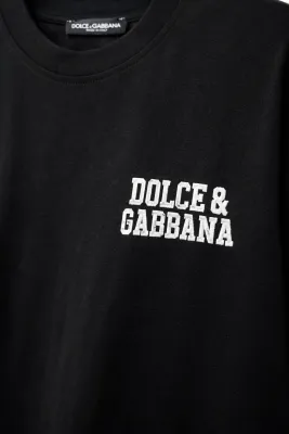 Dolce &amp; Gabbana embroidered chest logo close-up on black luxury men's designer t-shirt
