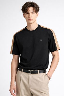 Male model wearing Burberry black t-shirt with check shoulder detail luxury designer men's outfit front view