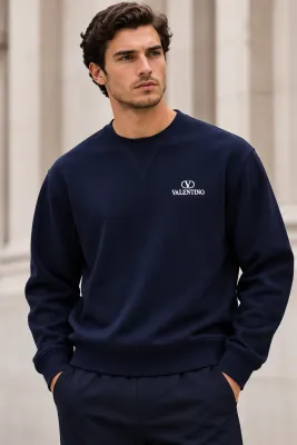 Male model wearing Valentino navy blue crewneck sweatshirt with white chest logo