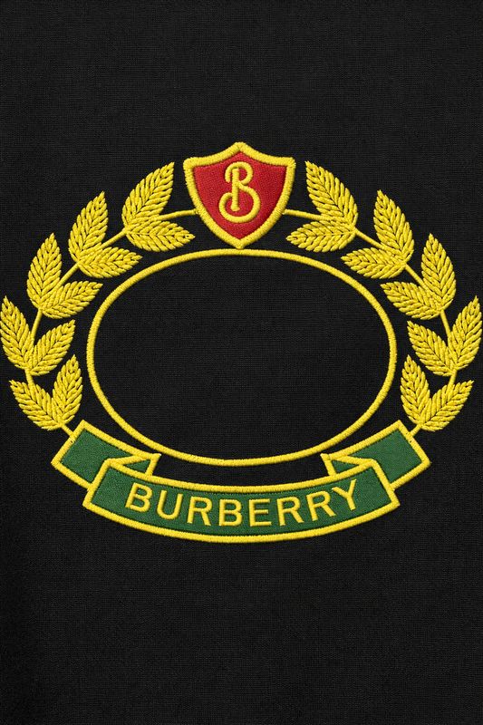 Burberry black men's designer t-shirt close up featuring embroidered crest logo and premium stitching detail
