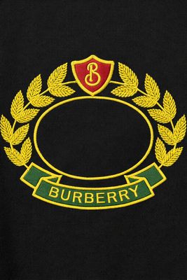 Burberry black men's designer t-shirt close up featuring embroidered crest logo and premium stitching detail