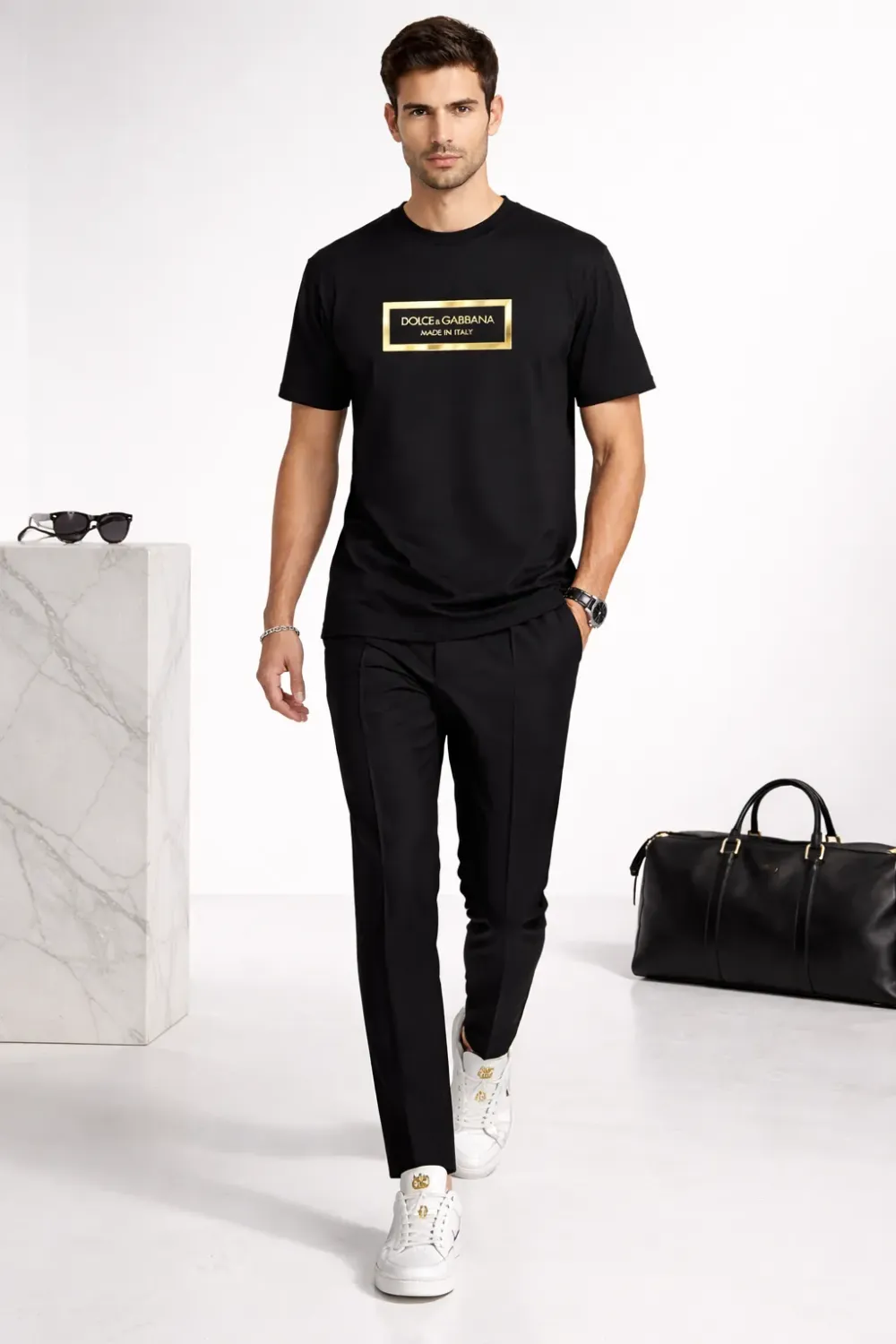 male model walking wearing dolce gabbana metal logo black designer t shirt luxury outfit