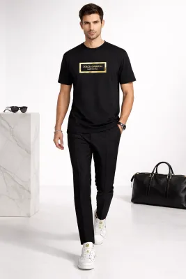 male model walking wearing dolce gabbana metal logo black designer t shirt luxury outfit