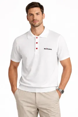 Male model wearing Kiton knitted white polo shirt with signature red buttons