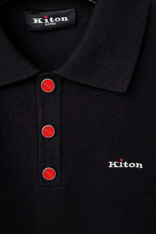Kiton black knit polo shirt close-up detail with red signature buttons and embroidered logo