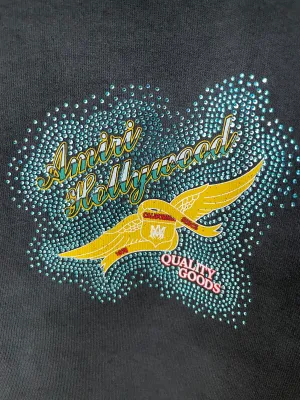 Close-up of Amiri black t-shirt rhinestone Hollywood logo and stone graphic detail