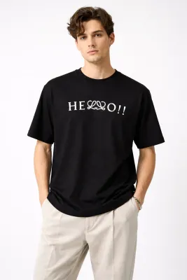 Male model wearing Loewe black hello print t-shirt front pose