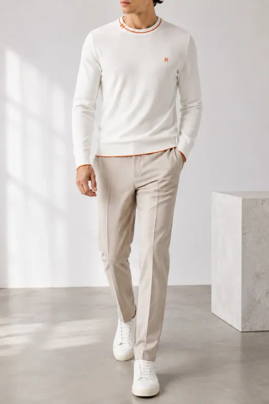 hermes white knit sweater men walking model with orange embroidered h logo