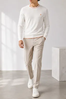 hermes white knit sweater men walking model with orange embroidered h logo