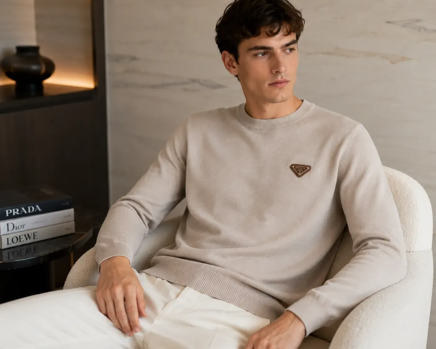 prada light beige knit sweater men seated model wearing signature triangle logo design