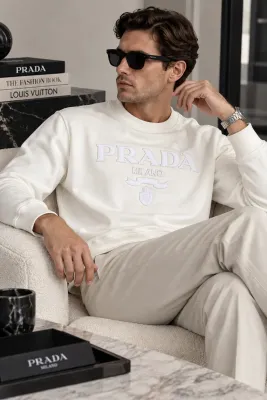 prada white logo sweatshirt men seated model wearing tonal Prada Milano embroidered design