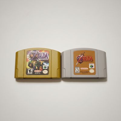 Zelda Ocarina of Time &amp; Zelda Majoras Mask Nintendo 64! Gold and grey Nintendo cartridges, clean.