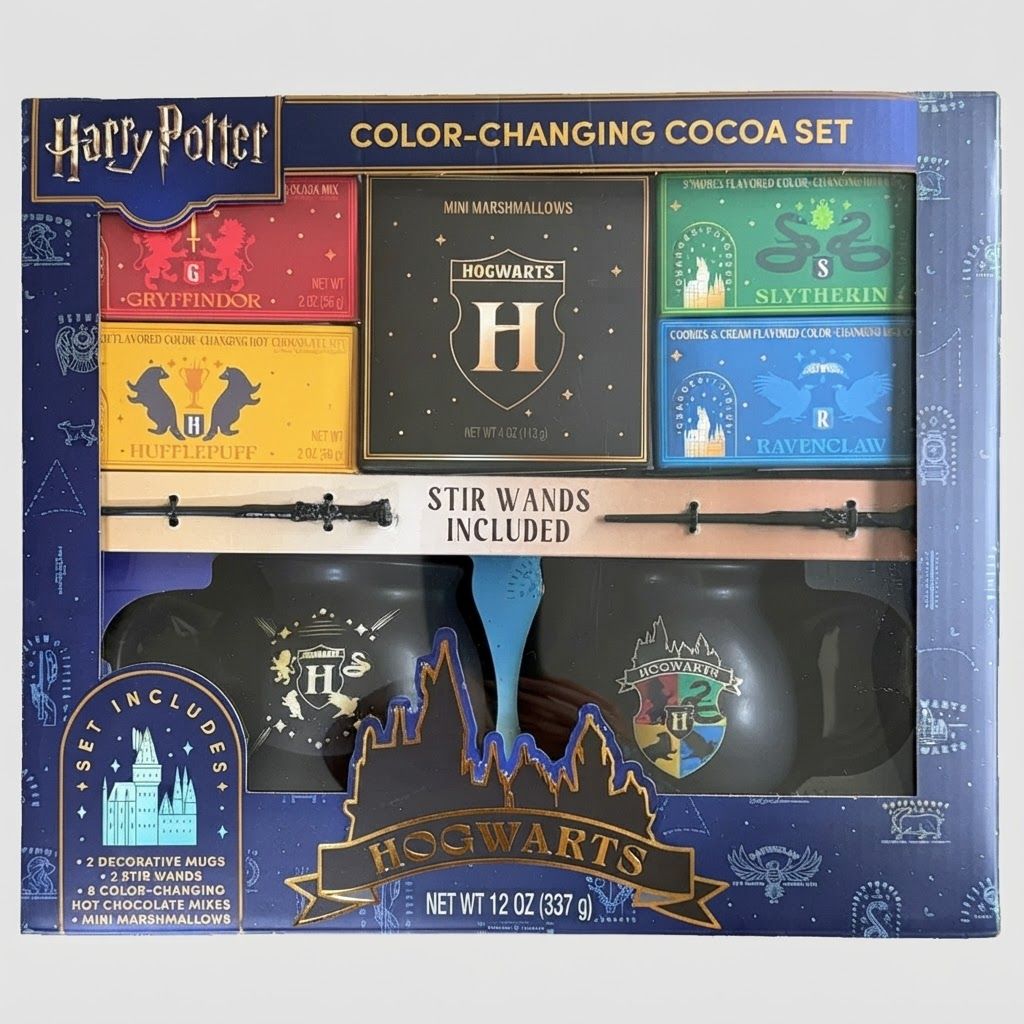 Front view of the Harry Potter Color-Changing Cocoa Kit showing black mugs, wand stirrers, and house-themed cocoa mixes