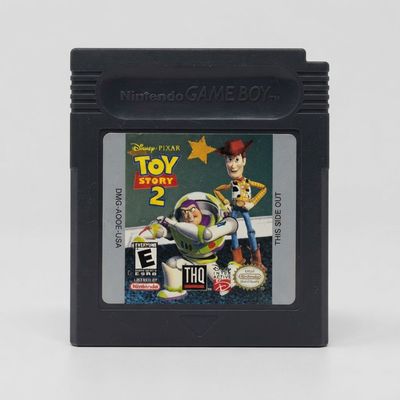 Front view of a Toy Story 2 Game Boy cartridge with a black shell and label featuring Woody and Buzz Lightyear