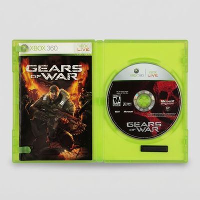 Open green Gears of War Xbox 360 case showing the game disc and instruction manual