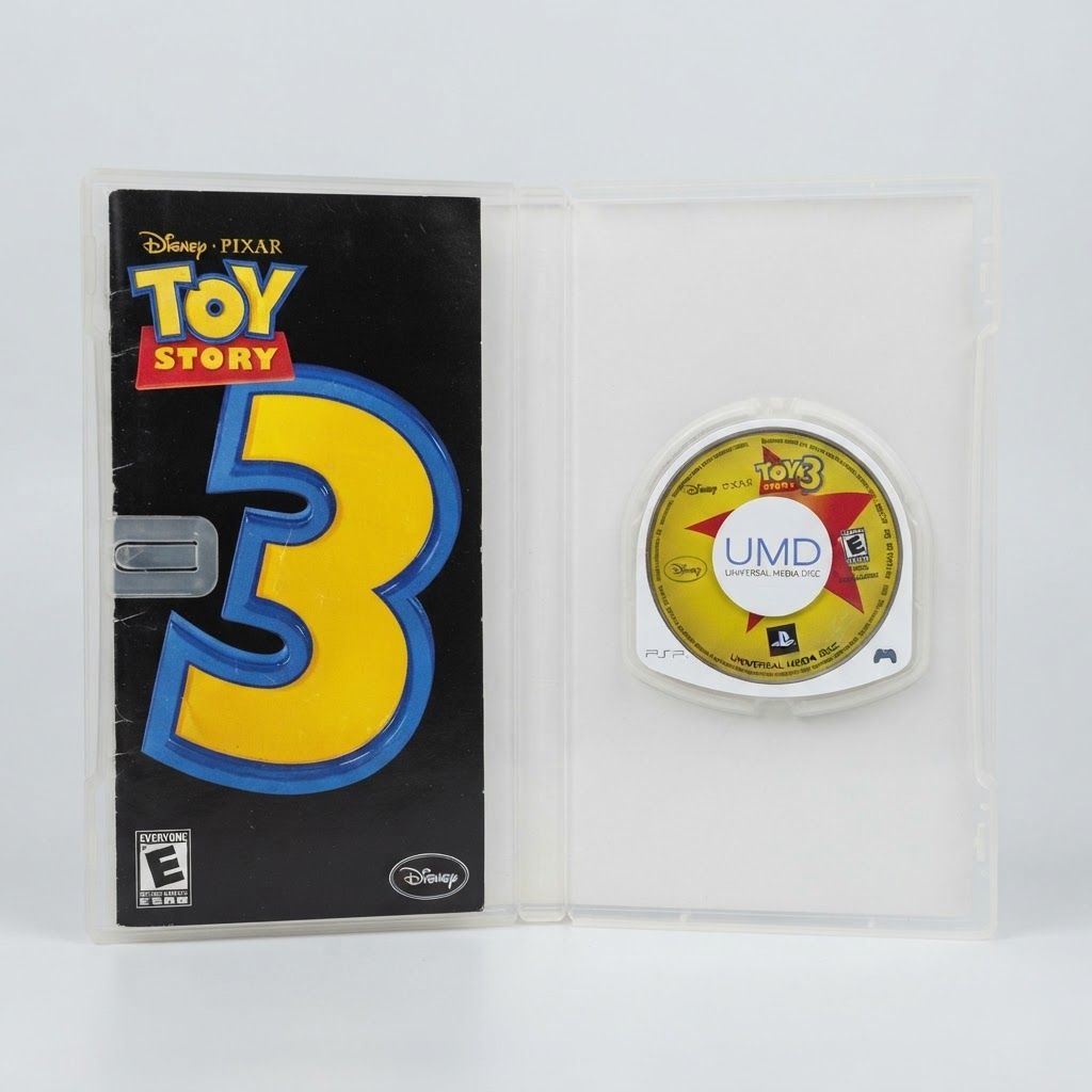 Open case for Disney Pixar Toy Story 3 on PSP showing the black manual and yellow UMD disc