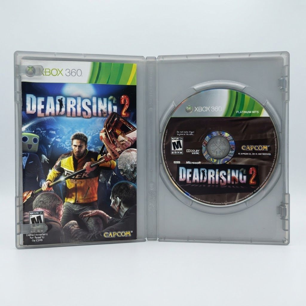Dead Rising 2 Platinum Hits for Xbox 360 shown in an open silver case with the manual and game disc visible