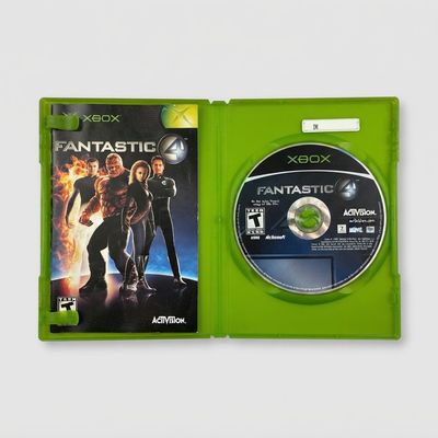 Open green case of Fantastic 4 for Xbox showing the game manual on the left and disc on the right