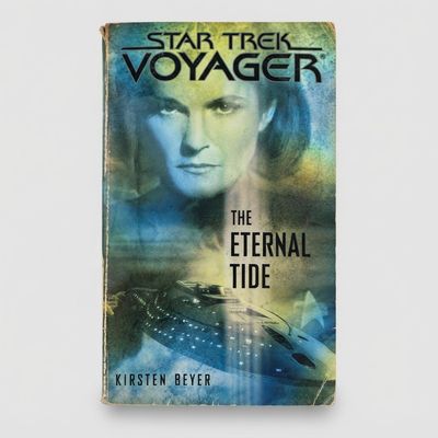 Front cover of the vintage Star Trek: Voyager The Eternal Tide paperback with blue and green atmospheric artwork