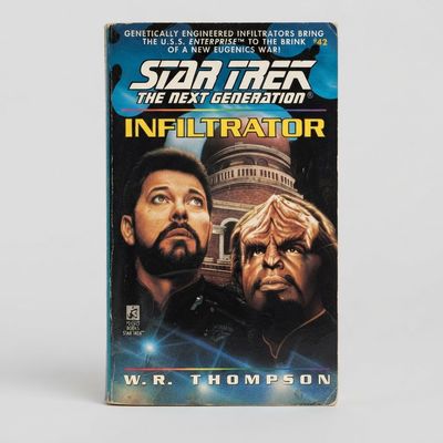Front cover of the vintage Star Trek: The Next Generation Infiltrator paperback featuring Riker and Worf artwork