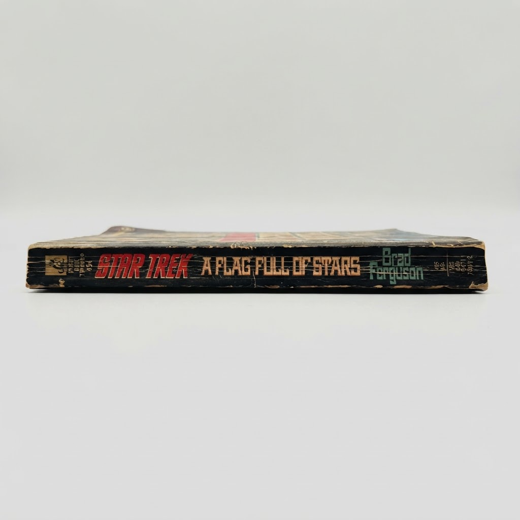 The black spine of the vintage Star Trek: The Original Series paperback A Flag Full of Stars shows wear and aging