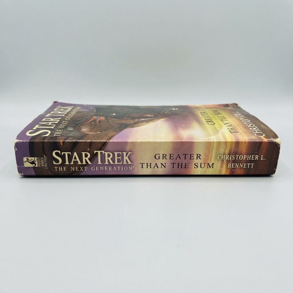 Spine view of the Star Trek: TNG Greater Than the Sum vintage paperback with purple and gold gradient cover art