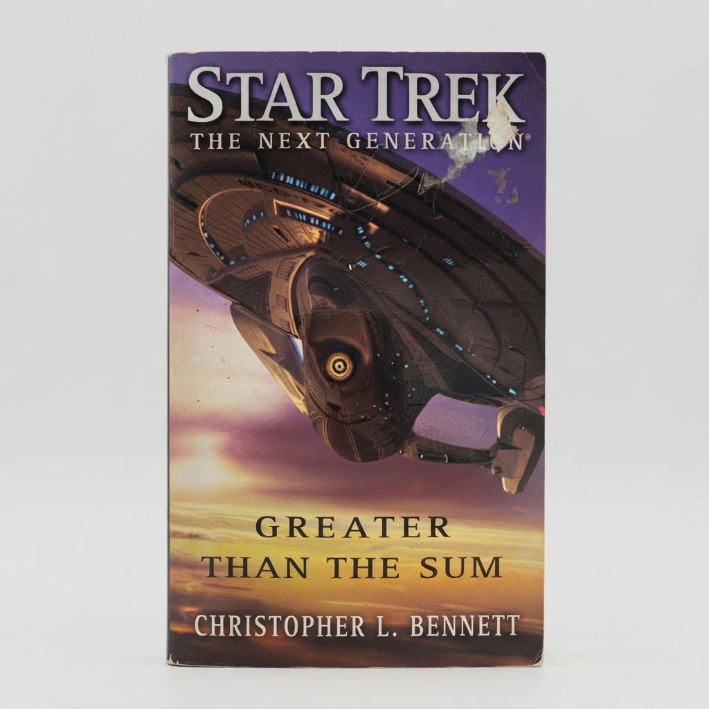Front cover of the Star Trek: TNG Greater Than the Sum paperback with visible paper wear and tearing near the top title