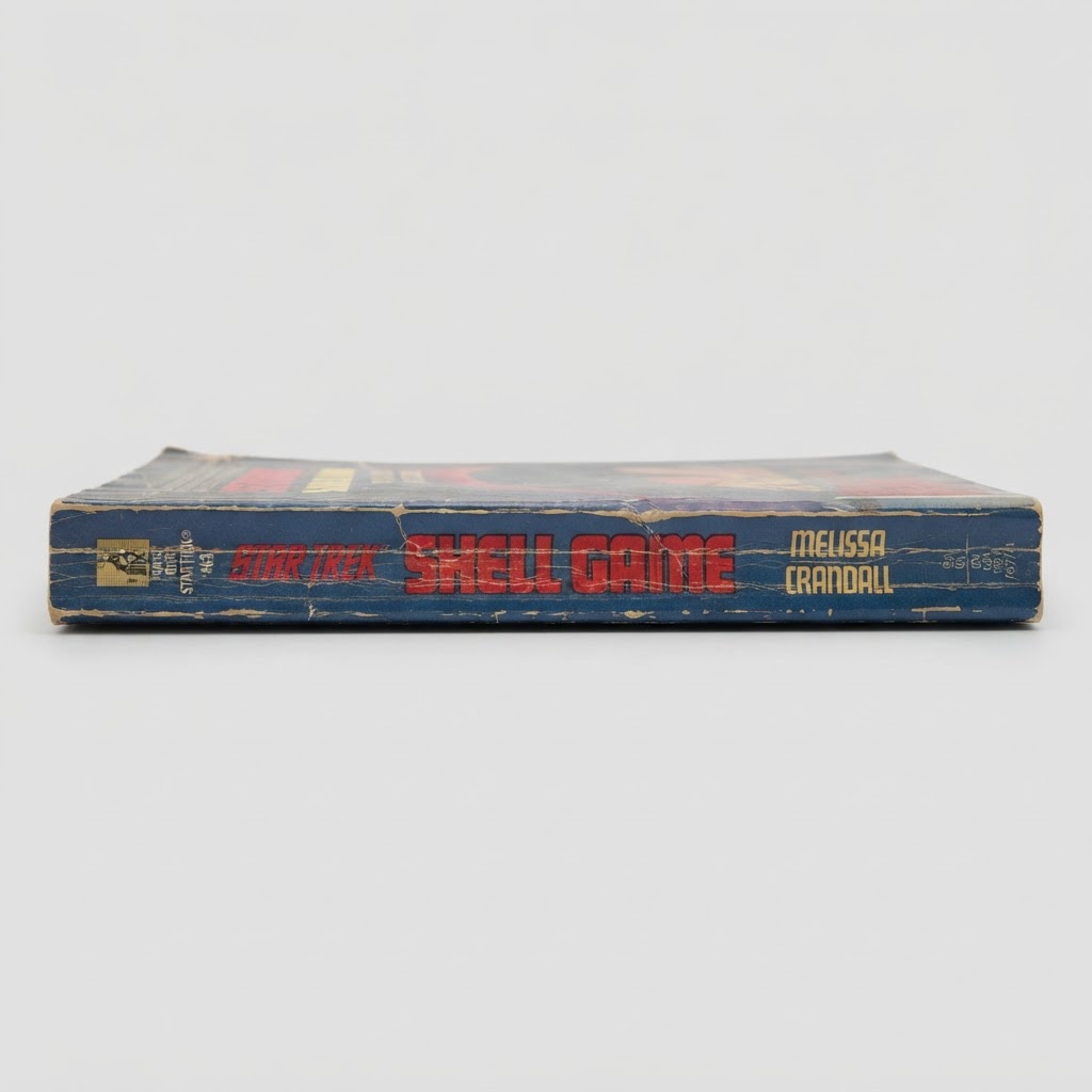 Spine view of the vintage Star Trek: The Original Series "Shell Game" paperback showing significant edge wear and creasing