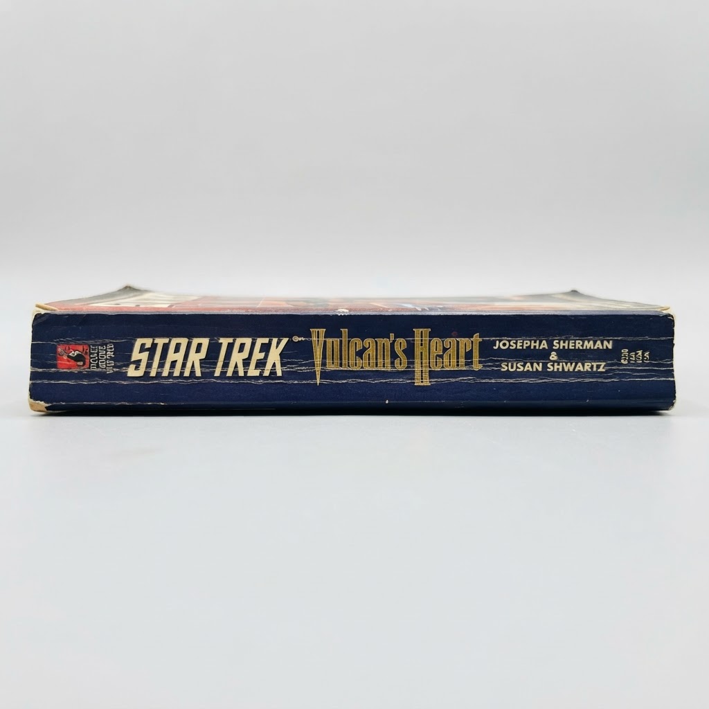 Blue spine of the vintage Star Trek "Vulcan's Heart" paperback featuring gold lettering and visible edge wear