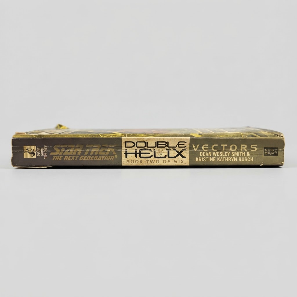 Spine view of the vintage Star Trek: TNG Double Helix: Vectors paperback in worn, gold and black condition