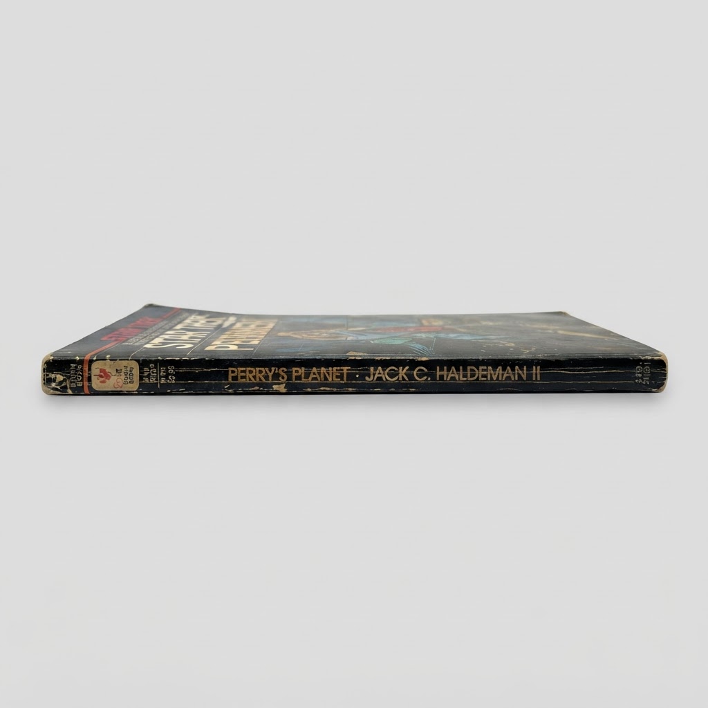 Side view of a worn Star Trek Perry's Planet vintage paperback featuring golden title text on a black spine