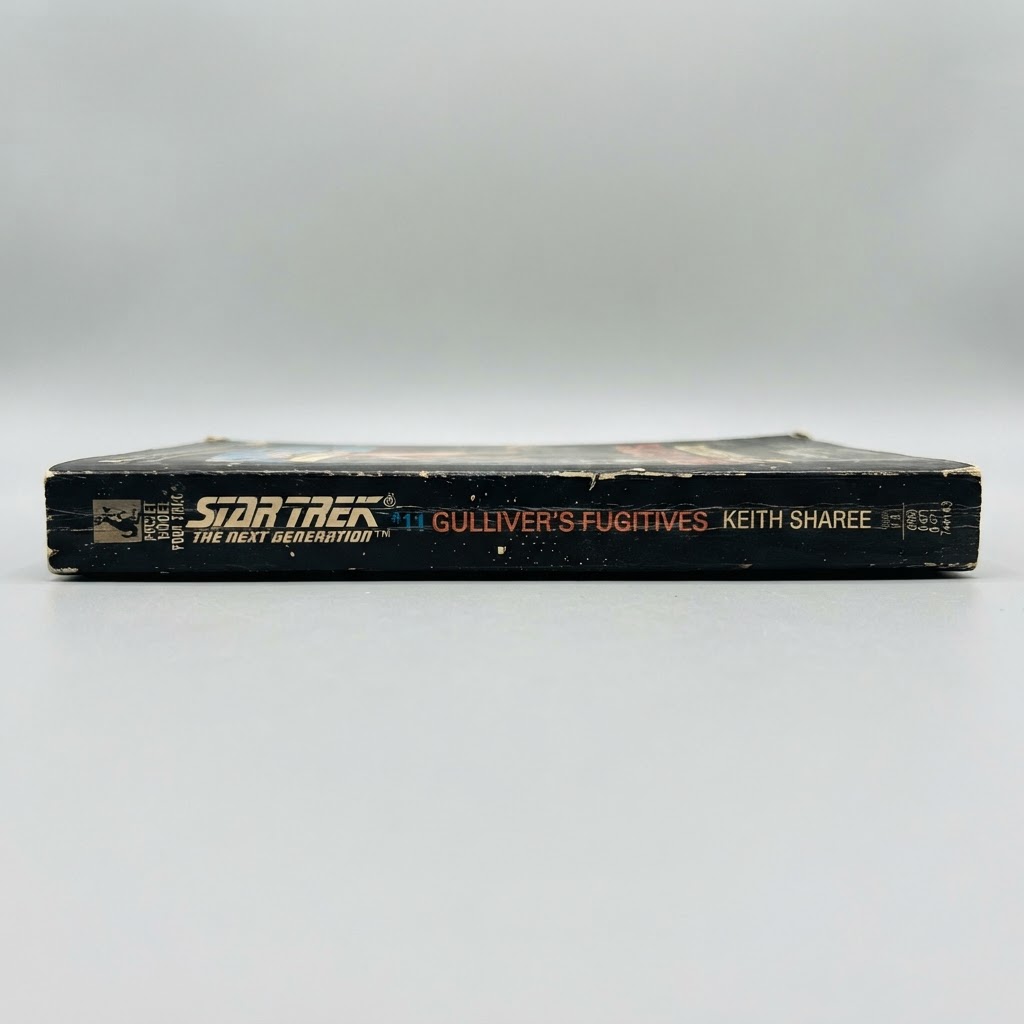 The black spine of the vintage Star Trek: TNG Gulliver's Fugitives #11 paperback showing light edge wear