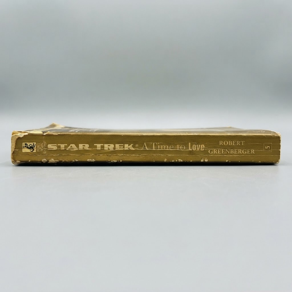 The worn gold spine of the Star Trek A Time to Love vintage paperback shows the title and author on a gray background