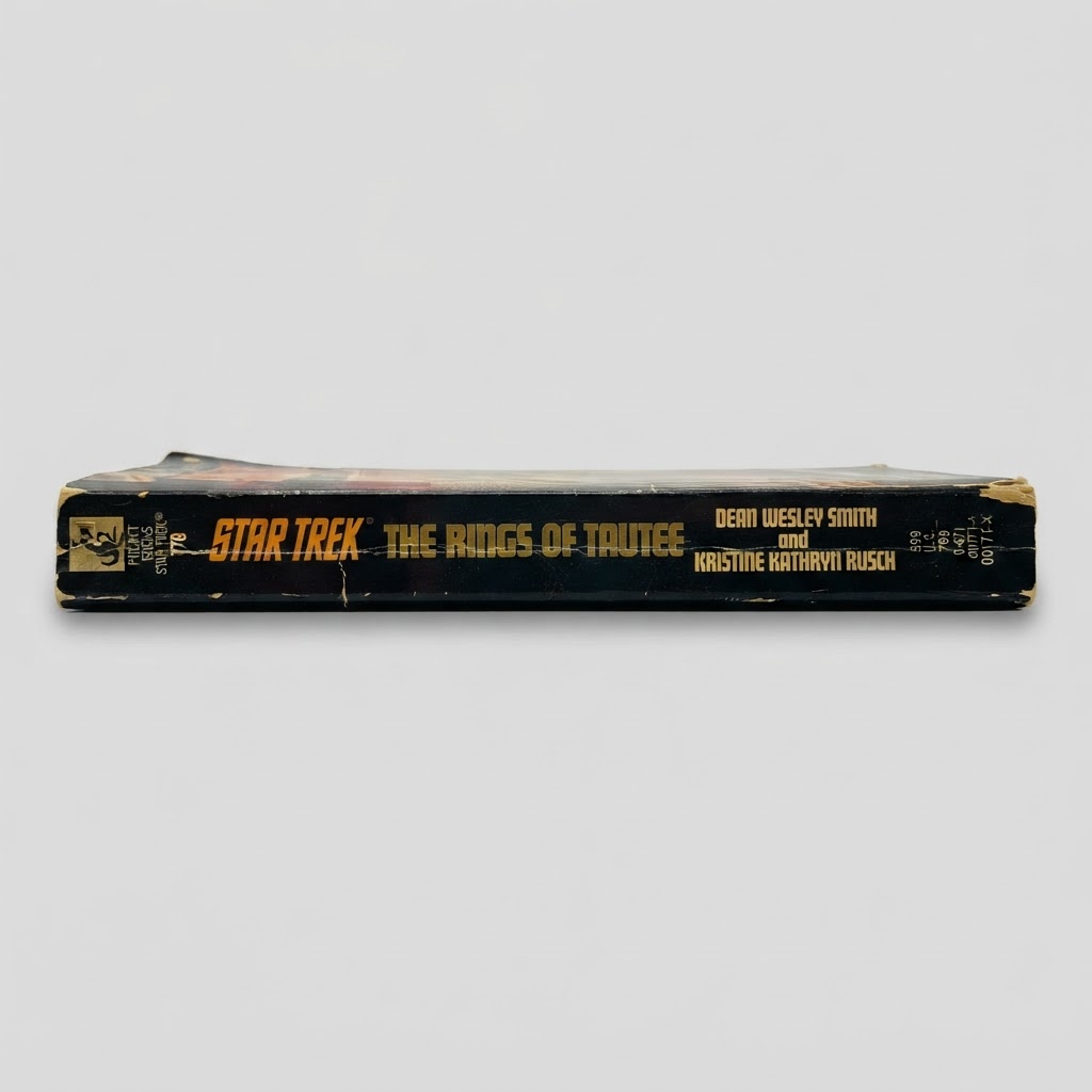 Black spine of the vintage Star Trek: The Rings of Tautee paperback with yellow text showing moderate edge wear