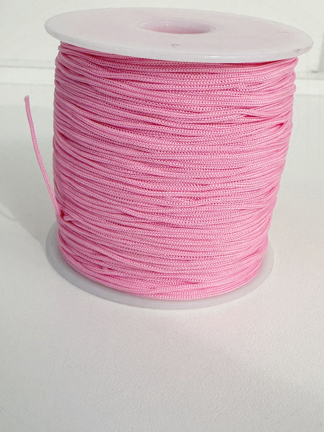 Nailoninis siūlas, 0,8mm, šviesiai rožinės spalvos, 100m ritė.