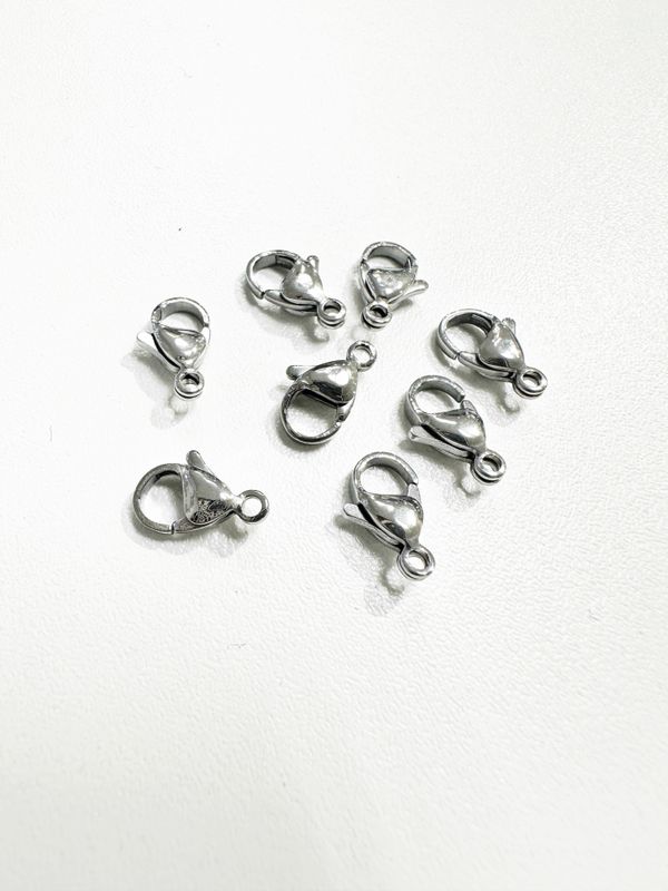 Nerūdijančio plieno užsegimai, plieno spalvos 9x6mm, 5vnt