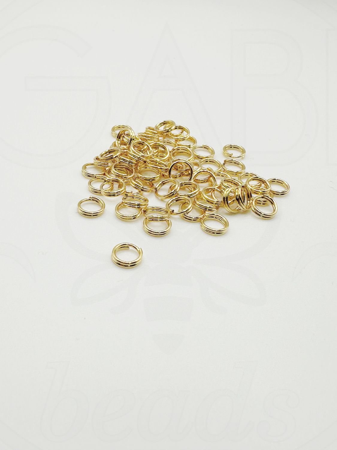Dvigubi nerūdijančio plieno žiedeliai, aukso spalvos 6x1mm, 15vnt