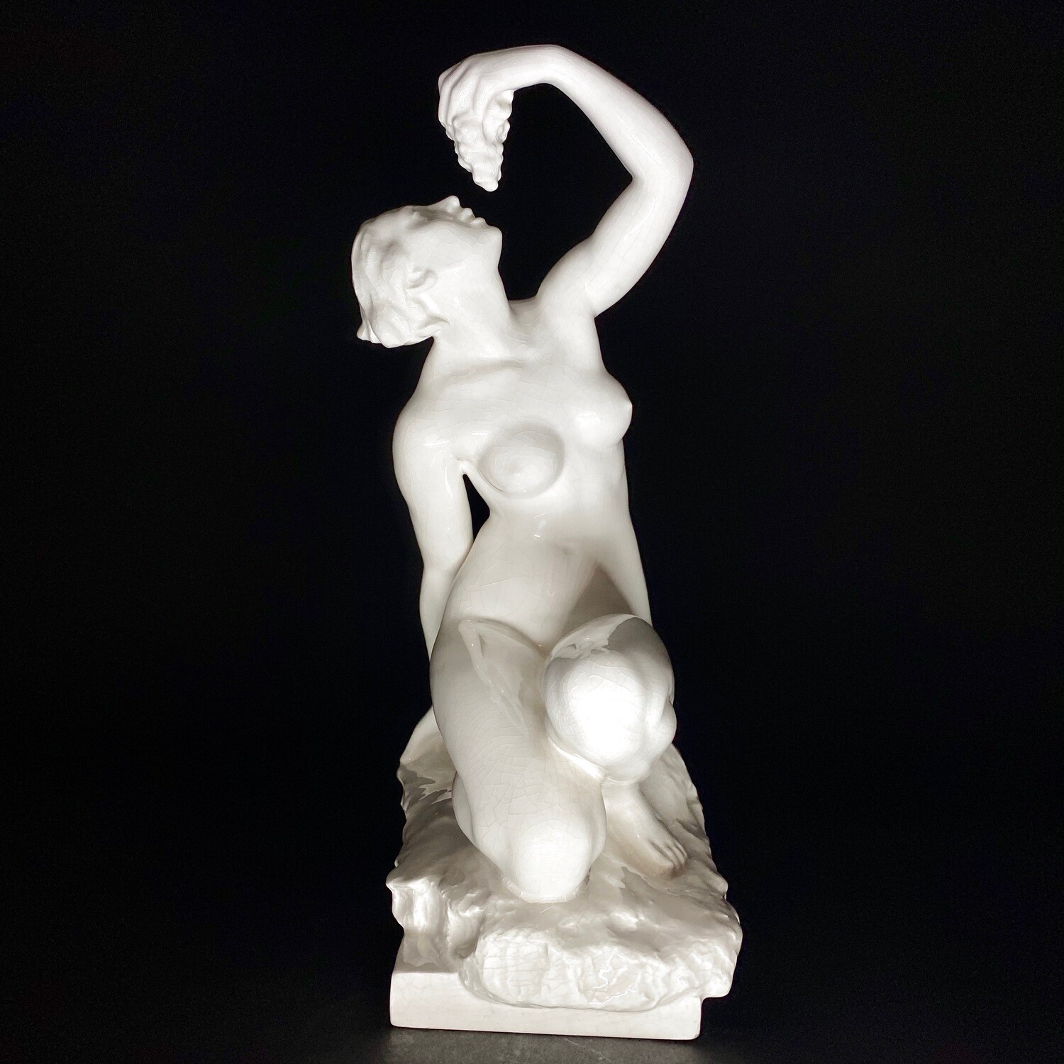 Czechoslovakian Art Deco White Glazed Ceramic Statue of a Kneeling Female Eating Grapes Designed by Jaroslav Hruska for Bechyne